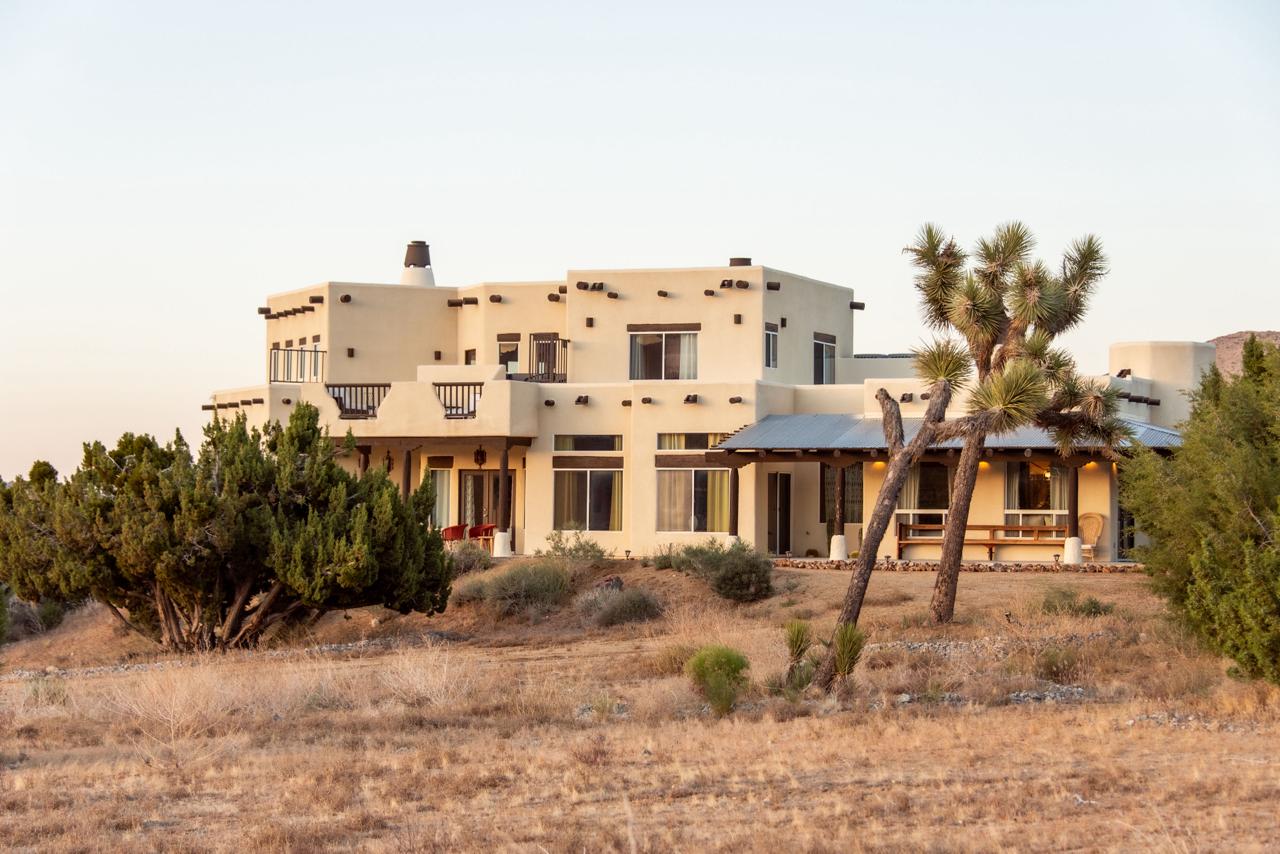 Gaia Villa's desert home with Joshua trees in front