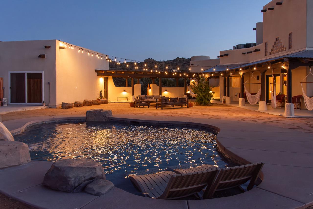 Gaia Villa's pool and courtyard lit at dusk