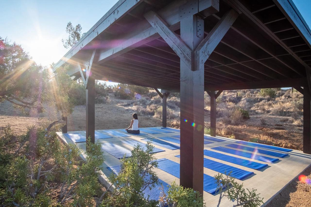 Covered yoga deck with mats laid out in the desert